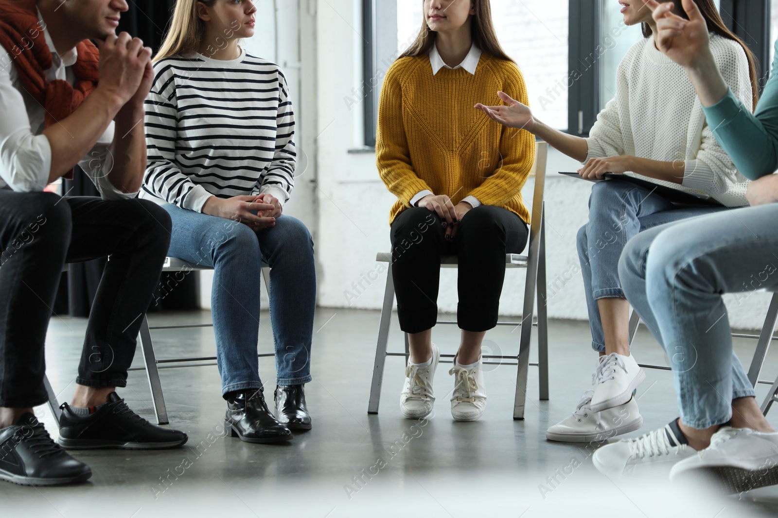 Photo of Psychotherapist working with patients in group therapy session, closeup