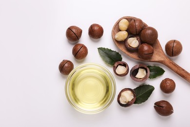 Photo of Delicious organic Macadamia nuts and natural oil on white background, flat lay. Space for text