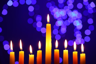 Photo of Hanukkah celebration. Burning candles against blurred lights