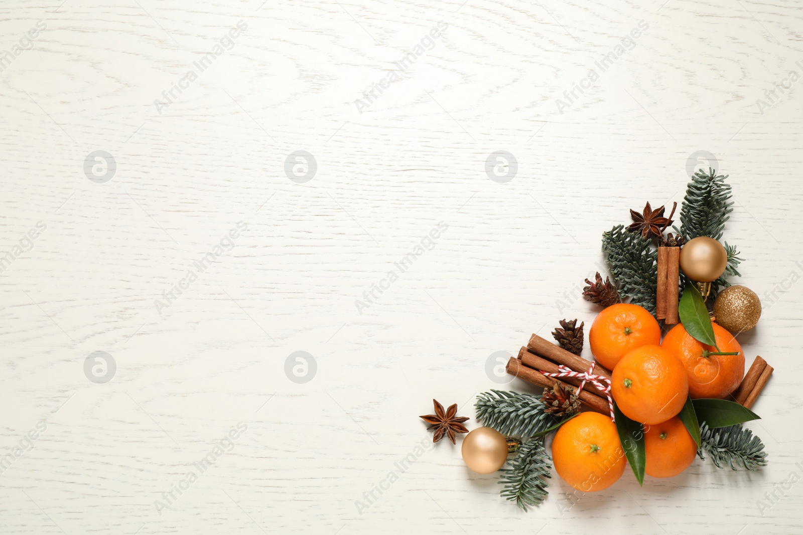 Photo of Christmas composition with tangerines on white wooden background, flat lay. Space for text