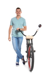 Photo of Portrait of handsome man with bicycle on white background