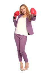 Photo of Happy young businesswoman with boxing gloves celebrating victory on white background