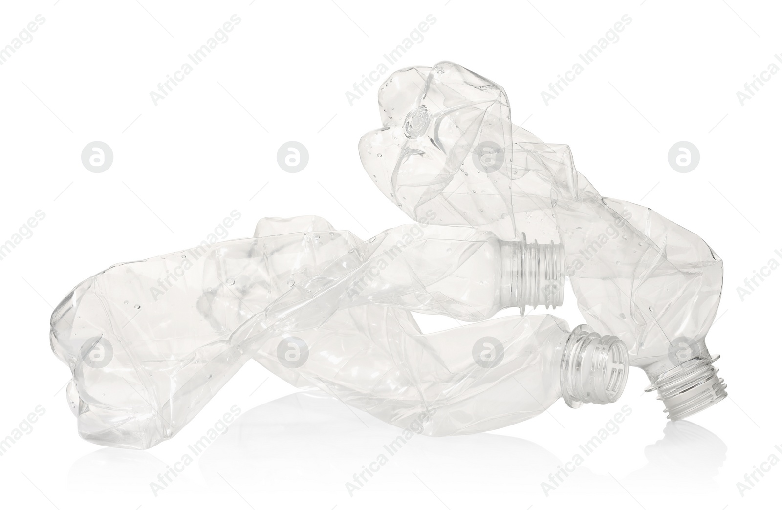 Photo of Crumpled disposable plastic bottles isolated on white