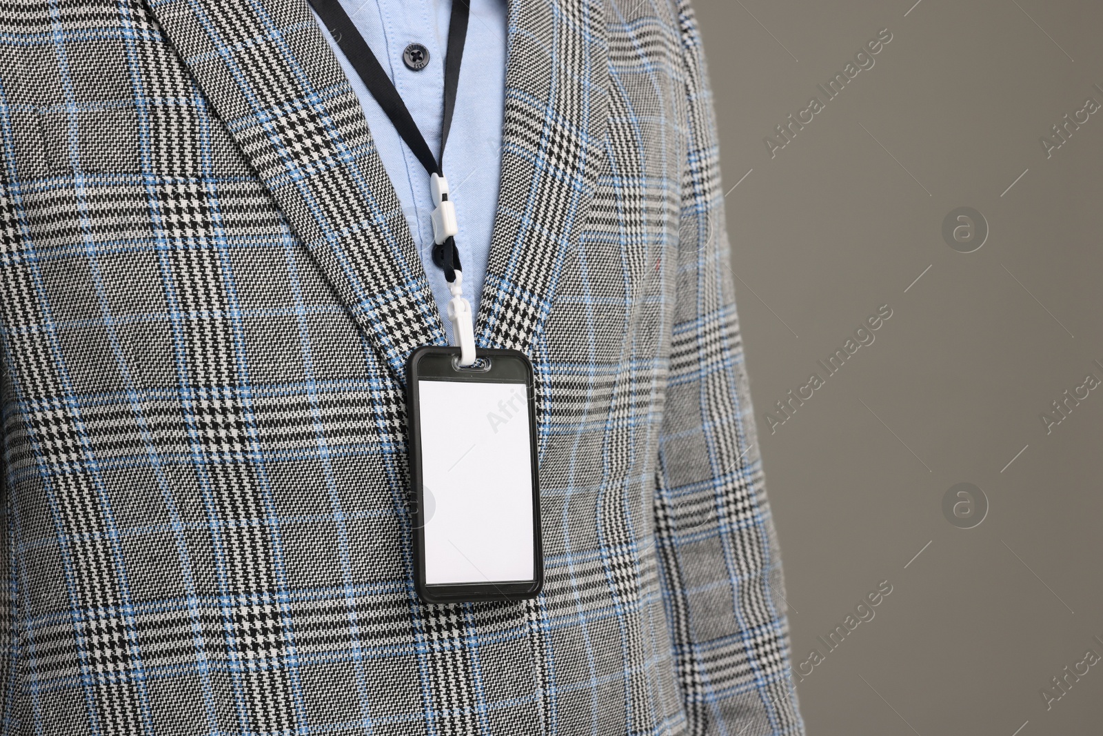 Photo of Man with blank badge on grey background, closeup. Space for text