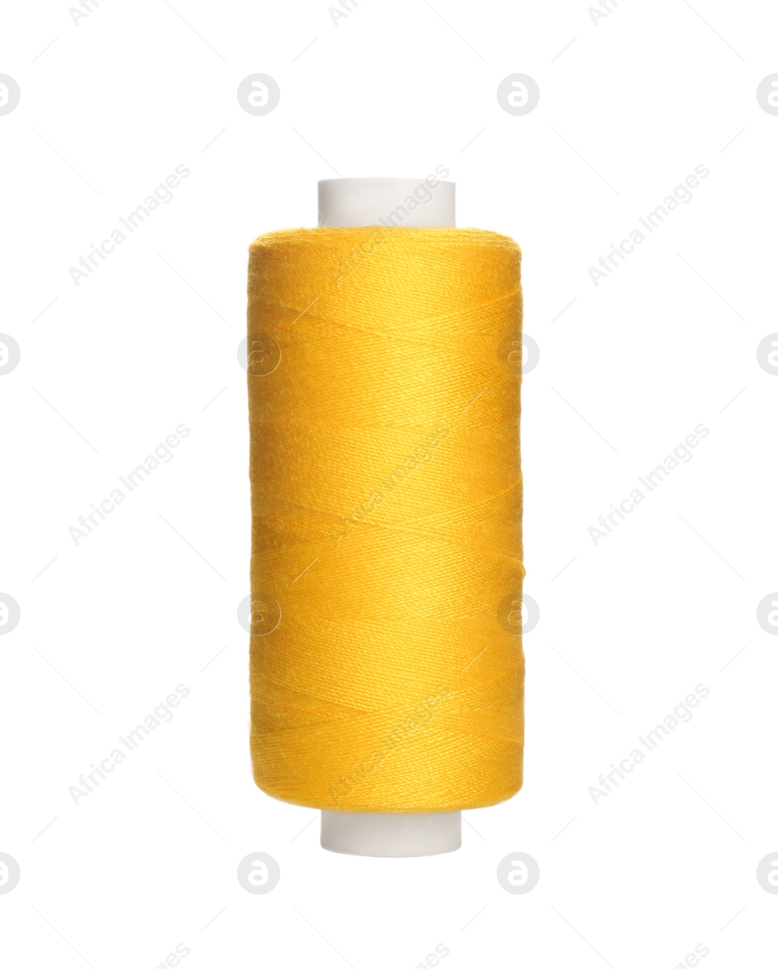 Photo of Spool of yellow sewing thread isolated on white