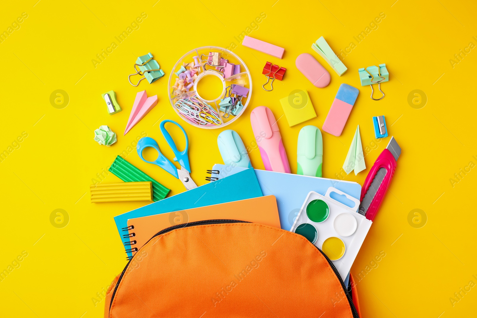 Photo of Flat lay composition with different school stationery on yellow background. Back to school