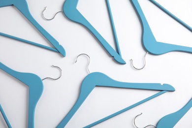 Photo of Empty clothes hangers on white background, top view