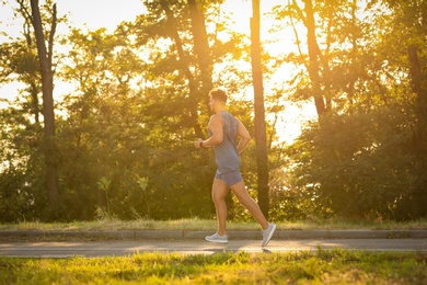 Photo of Young man running in park on sunny day