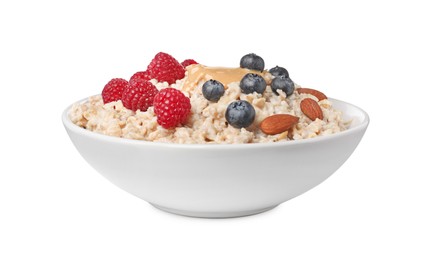 Photo of Tasty boiled oatmeal with berries, almonds and peanut butter in bowl isolated on white