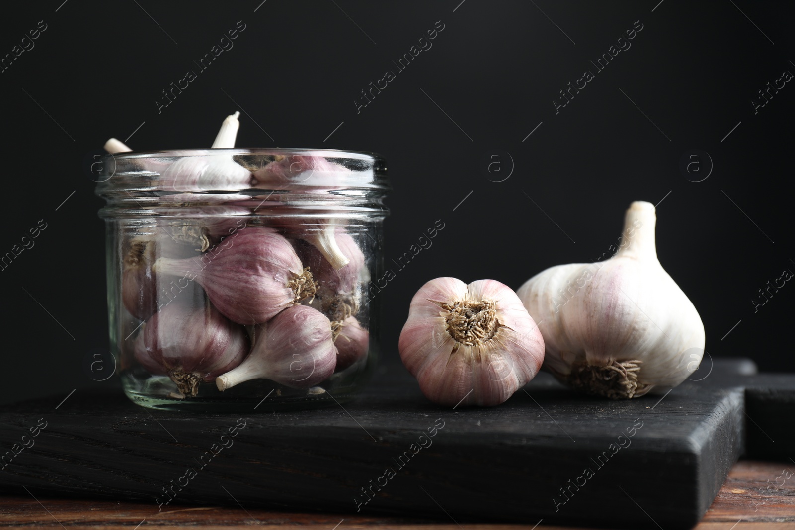 Photo of Many fresh garlic bulbs on wooden table, closeup