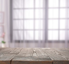 Image of Empty wooden surface and blurred view of modern window  