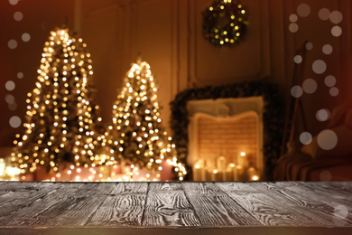 Empty wooden surface and blurred view of room decorated for Christmas