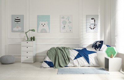 Photo of Bed with stylish linens in children's room