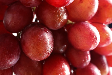 Bunch of red fresh ripe juicy grapes as background, closeup