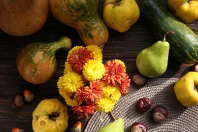 Photo of Autumn flat lay composition with beautiful chrysanthemum flowers and pumpkins on wooden table