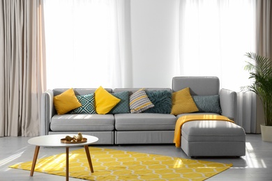 Stylish living room interior with comfortable sofa. Space for text