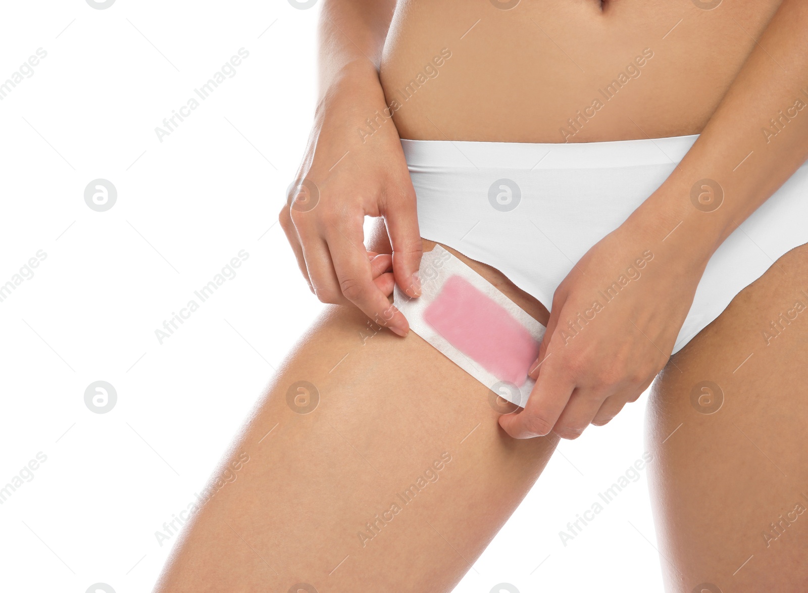 Photo of Young woman waxing bikini area on white background