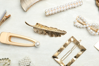 Beautiful different hair clips on white table, flat lay