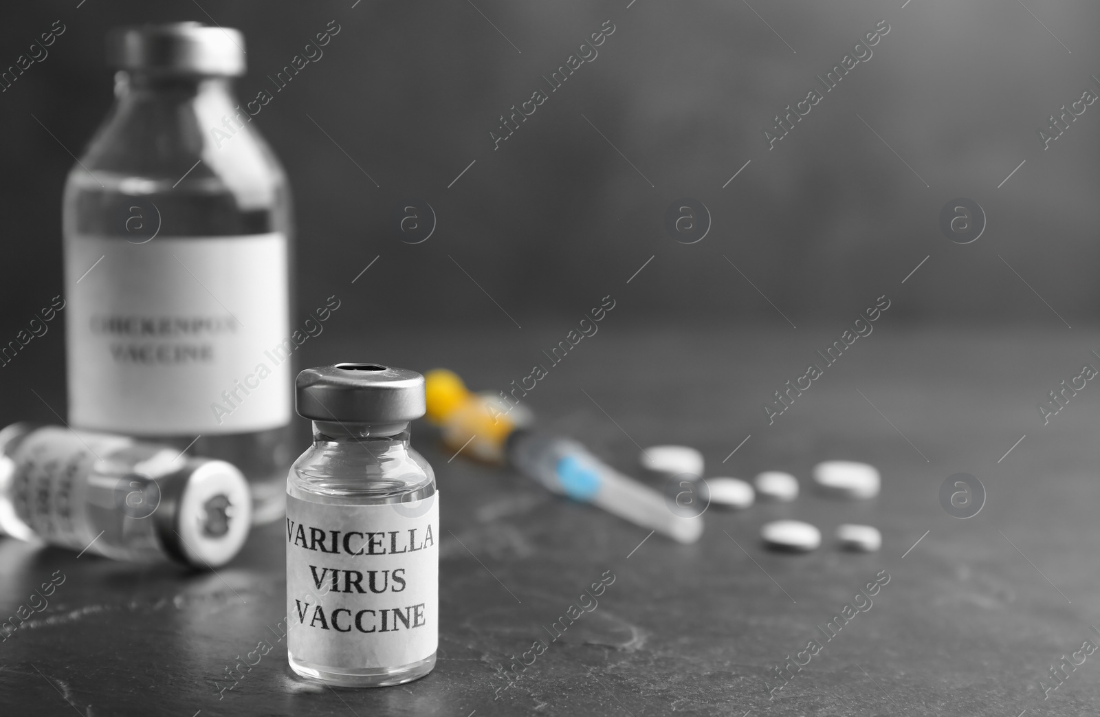 Photo of Chickenpox vaccine and syringe on grey background, space for text. Varicella virus prevention