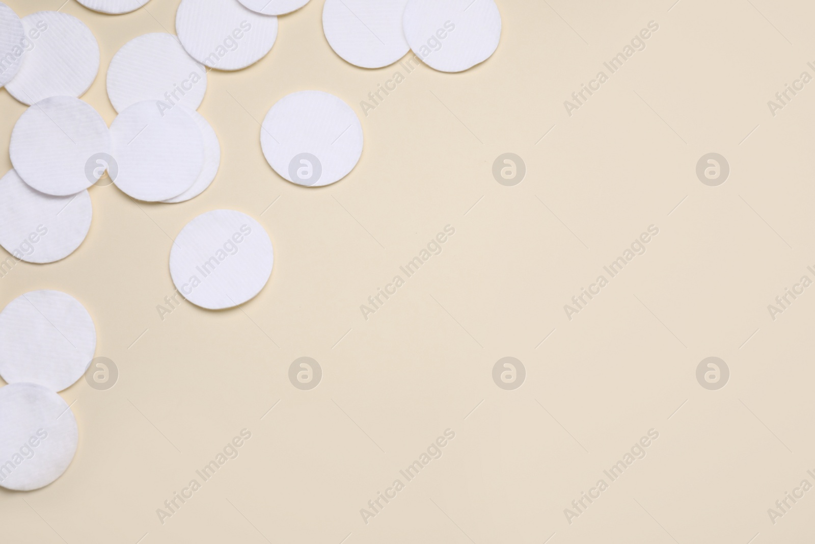 Photo of Many clean cotton pads on yellow background, flat lay. Space for text