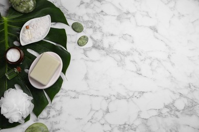 Photo of Flat lay composition with different spa products and tropical leaf on white marble table. Space for text