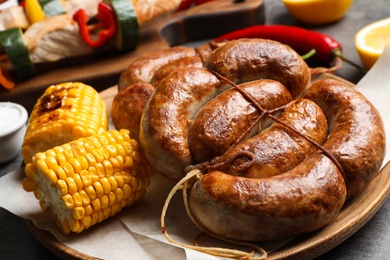 Photo of Barbecued meat and vegetables on table, closeup