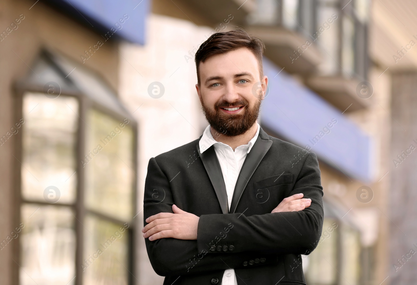 Photo of Portrait of young businessman in stylish outfit outdoors