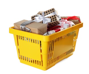 Photo of Shopping basket full of gift boxes on white background