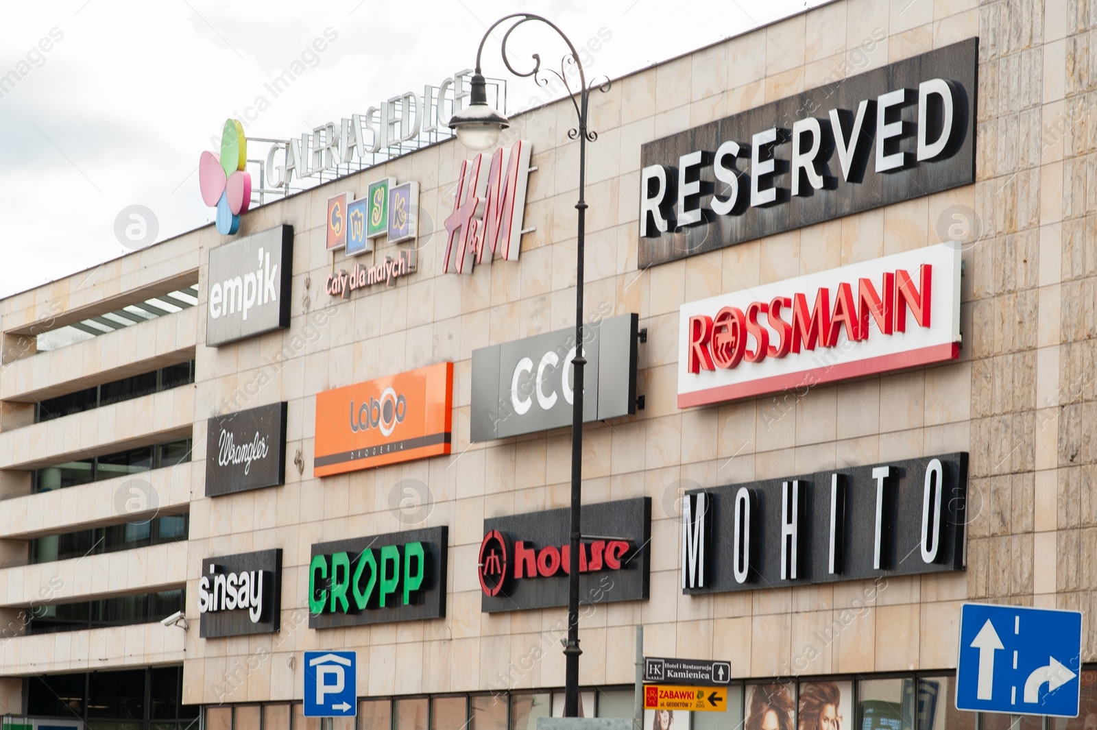 Photo of SIEDLCE, POLAND - AUGUST 30, 2022: Shopping mall with different store brand logos outdoors