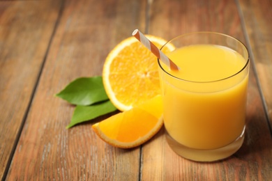 Glass of orange juice and fresh fruits on wooden table. Space for text