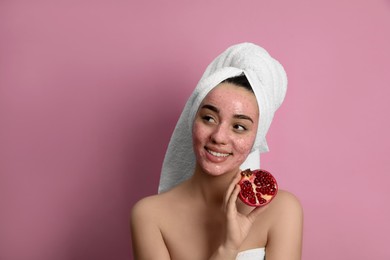 Woman with pomegranate face mask and fresh fruit on pink background