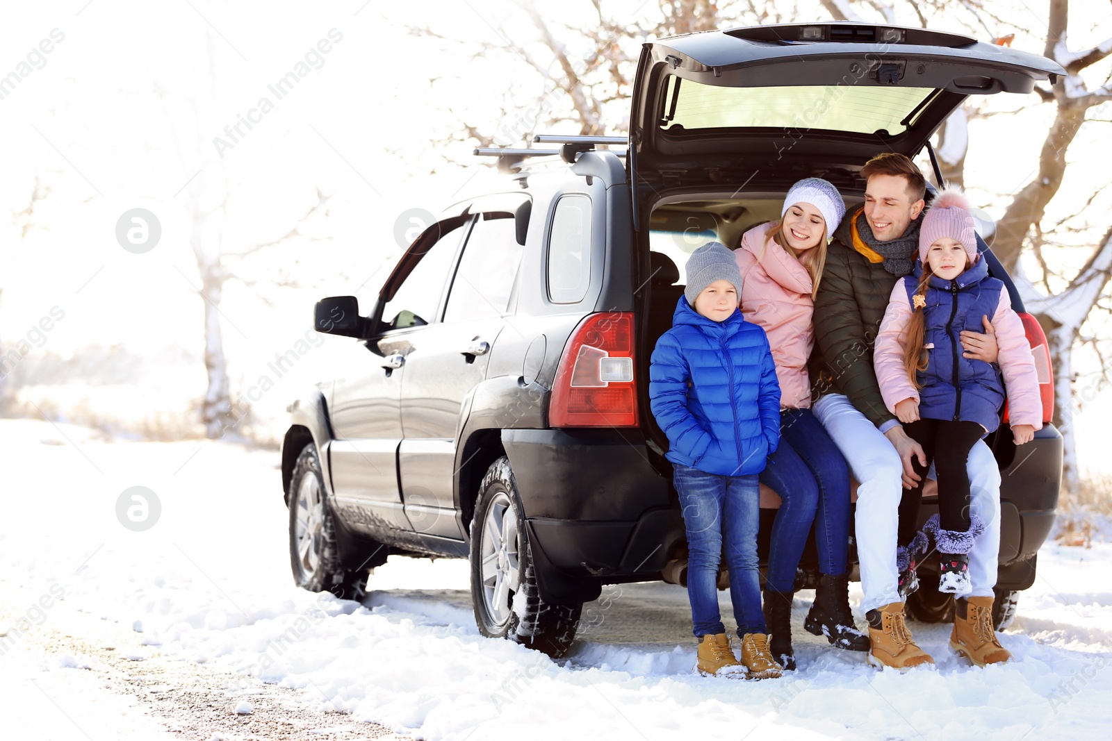 Photo of Happy family near car on winter day