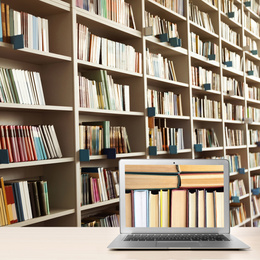 Image of Digital library concept. Modern laptop on table and shelves with books indoors