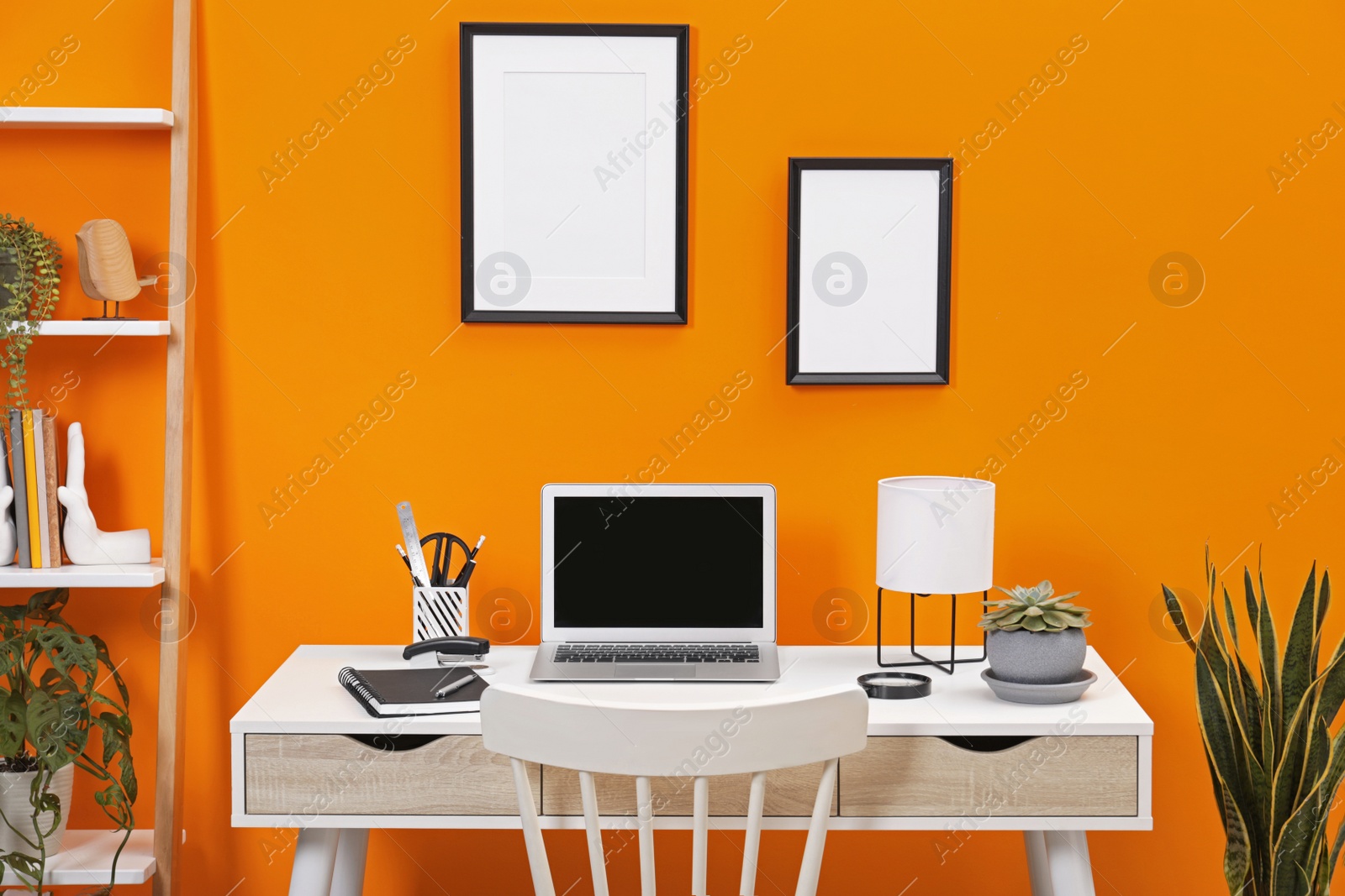 Photo of Workplace with laptop, stationery on desk and chair in home office