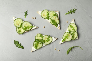 Photo of Flat lay composition with traditional English cucumber sandwiches on grey background