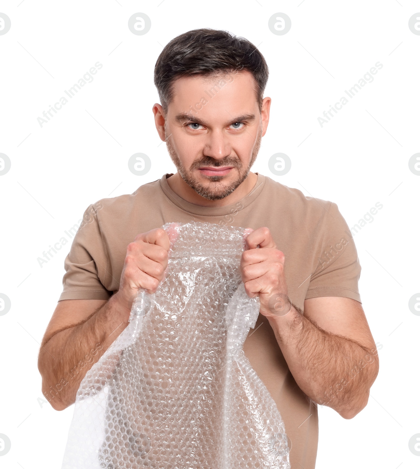 Photo of Emotional man with bubble wrap on white background