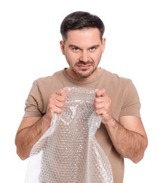 Emotional man with bubble wrap on white background