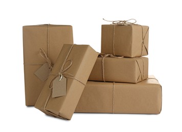 Parcels wrapped in kraft paper with tags on white background