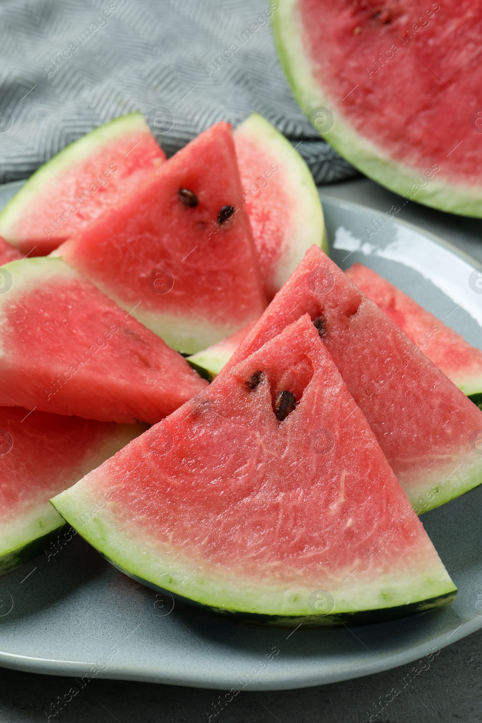 Photo of Delicious fresh watermelon slices on plate, closeup