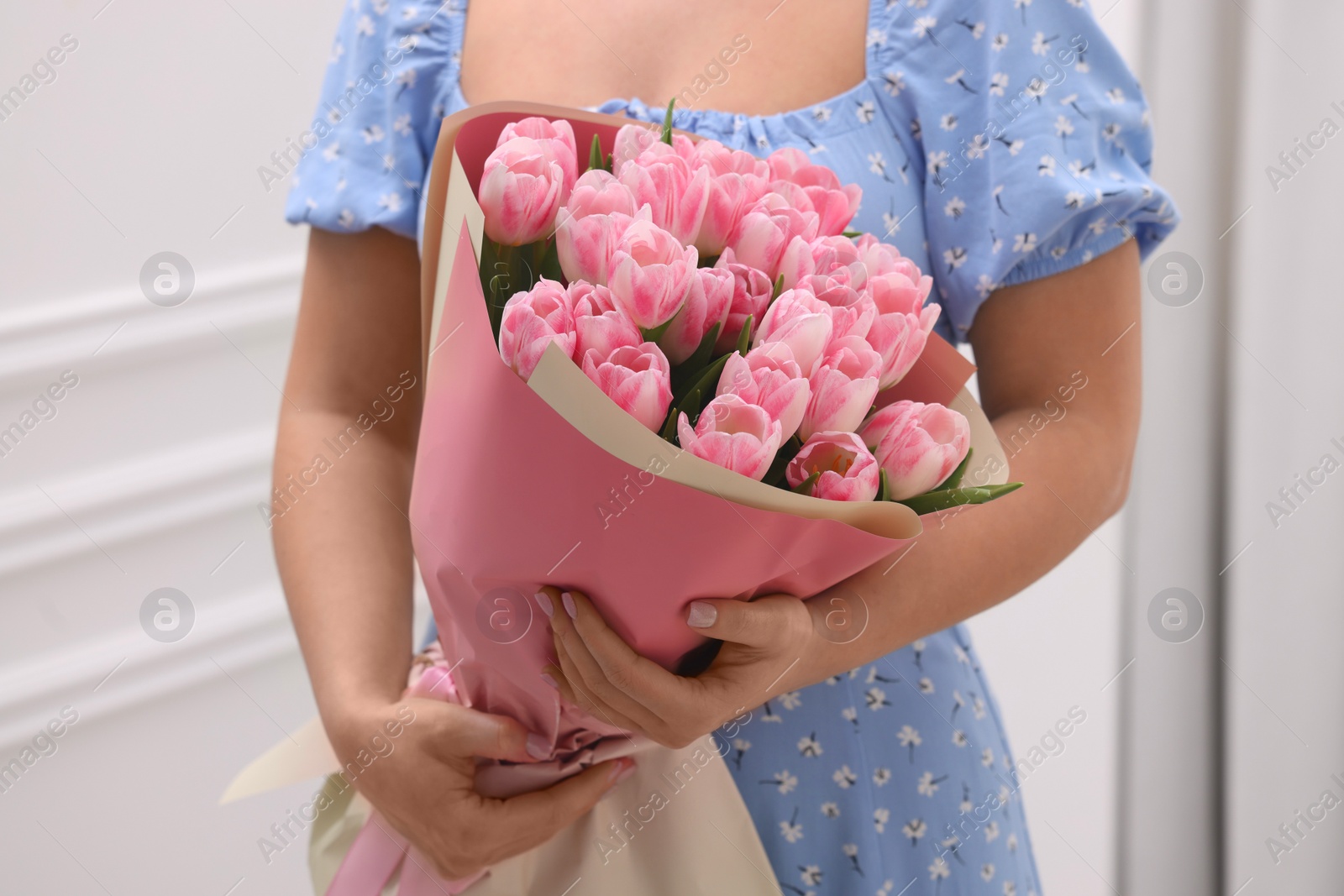 Photo of Woman with bouquet of beautiful fresh tulips on blurred background, closeup