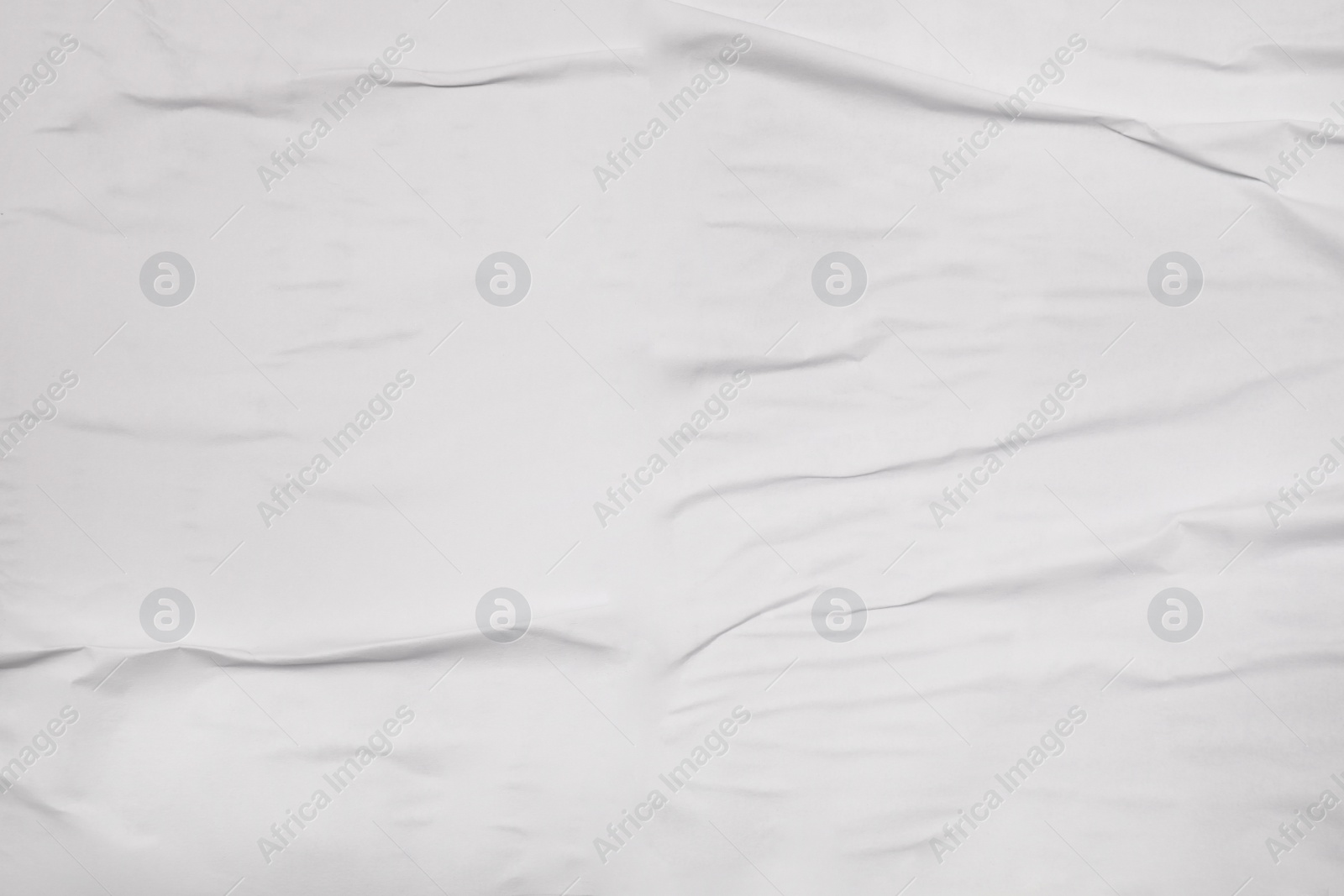 Photo of Top view of white creased blank poster as background, closeup