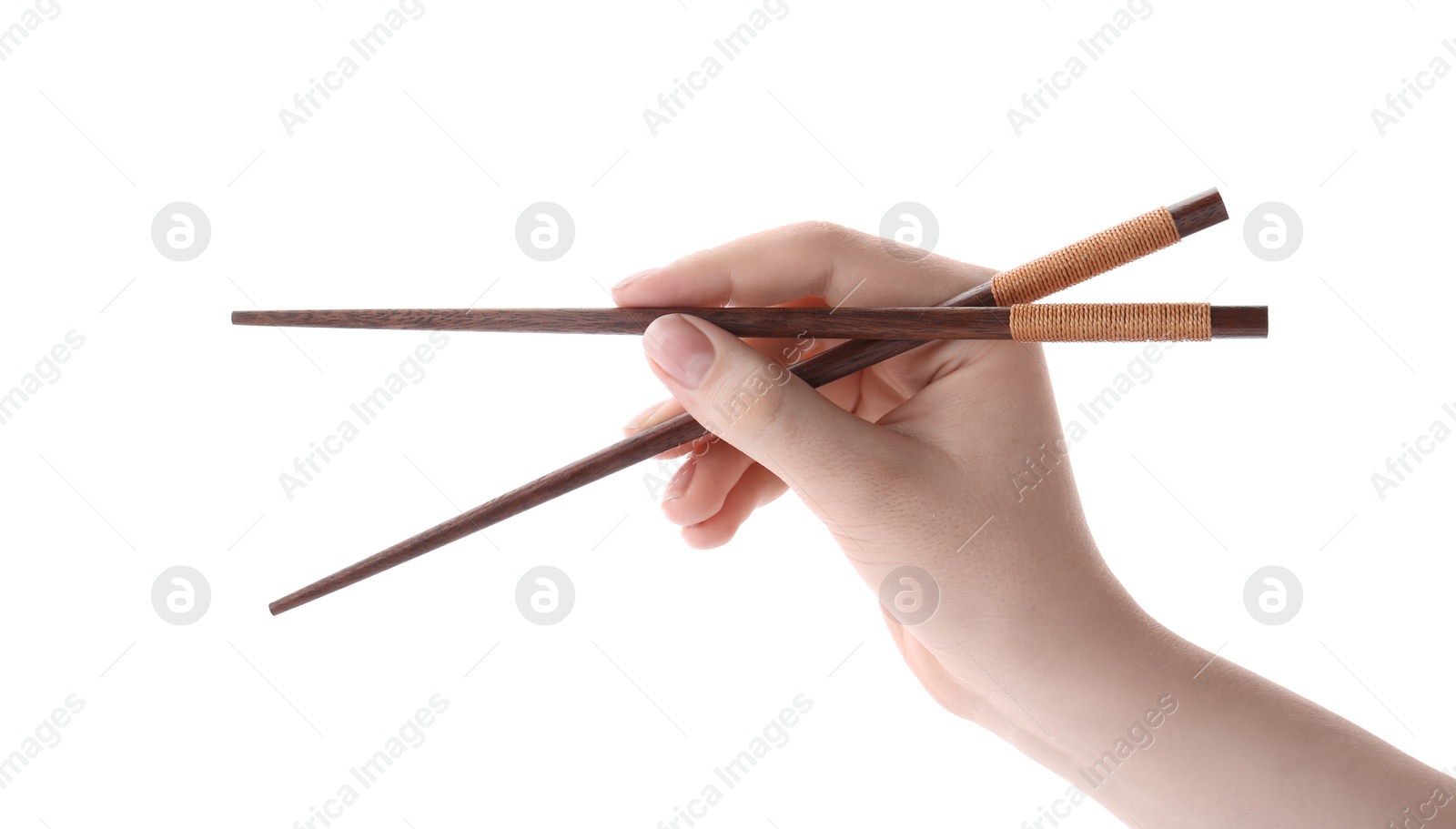 Photo of Woman holding pair of wooden chopsticks on white background, closeup