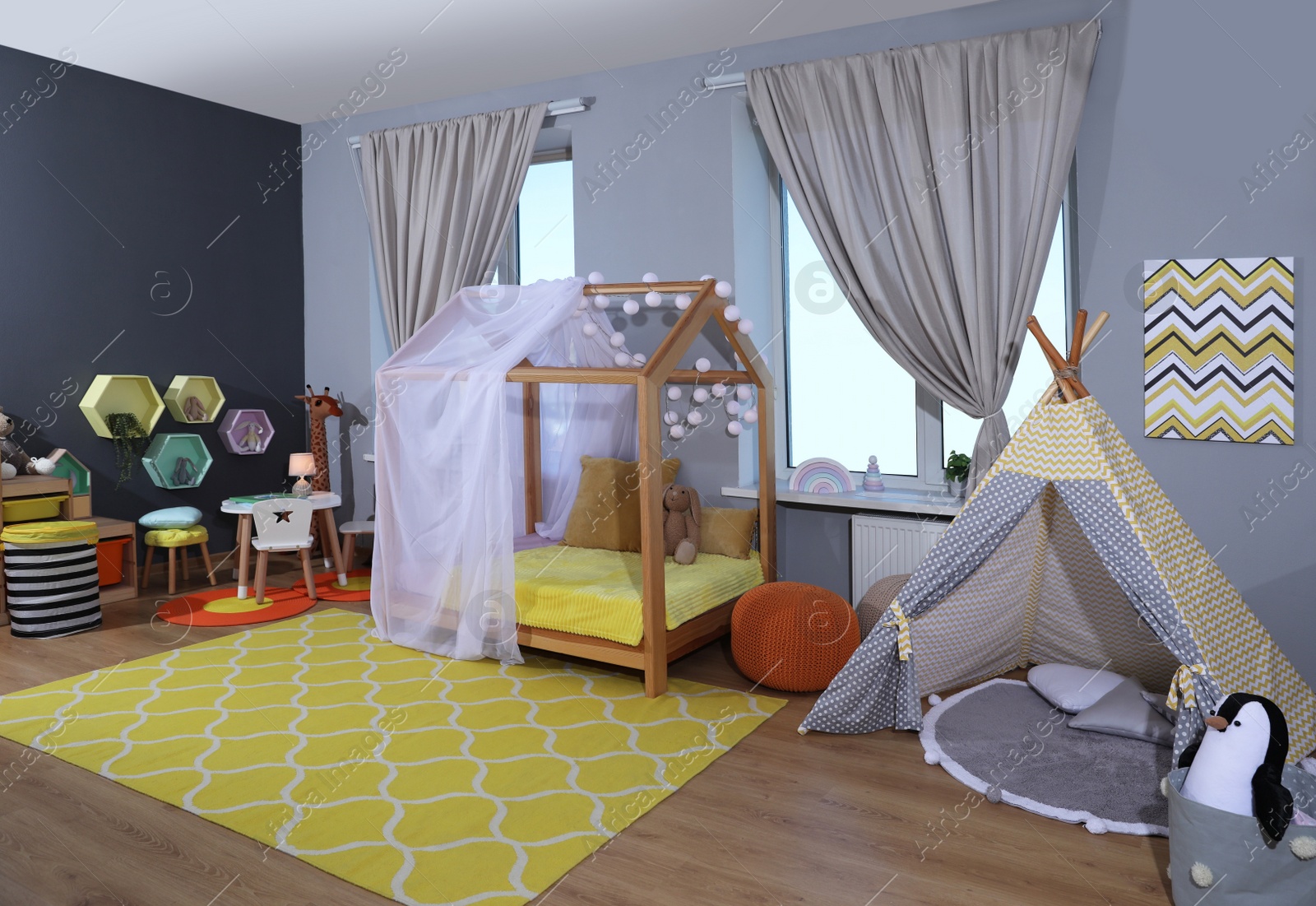 Photo of Stylish child room interior with comfortable house bed and play tent