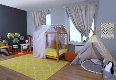 Photo of Stylish child room interior with comfortable house bed and play tent