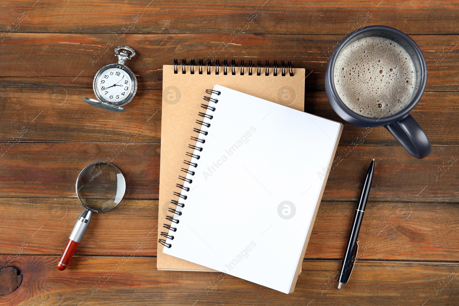 Photo of Flat lay composition with office stationery and cup of coffee on wooden table. Space for design