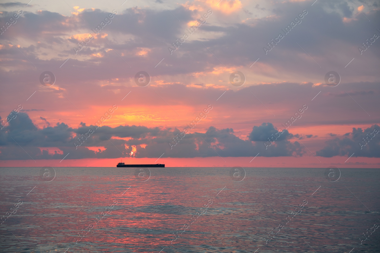 Photo of Picturesque view of sunset with clouds over sea