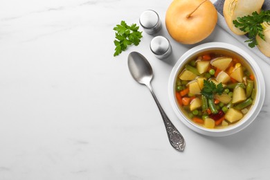 Photo of Bowl of delicious turnip soup served on white table, flat lay. Space for text