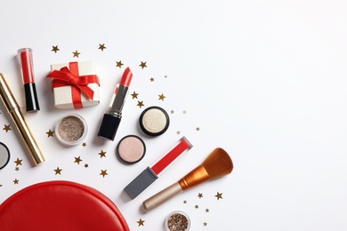 Photo of Flat lay composition with makeup products and Christmas decor on white background. Space for text
