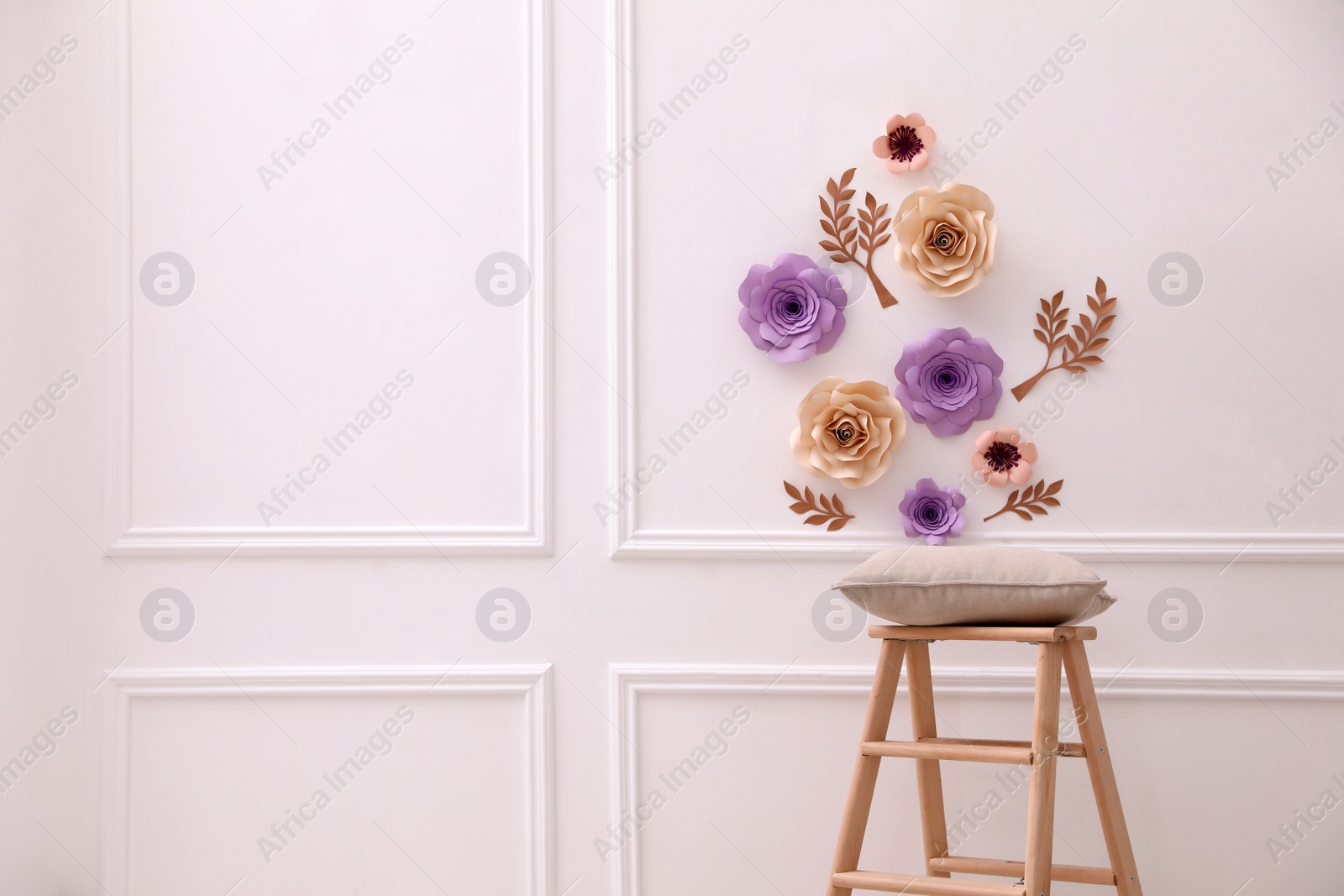 Photo of Stylish room interior with floral decor and wooden stand, space for text