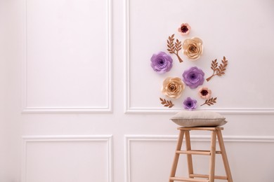 Photo of Stylish room interior with floral decor and wooden stand, space for text